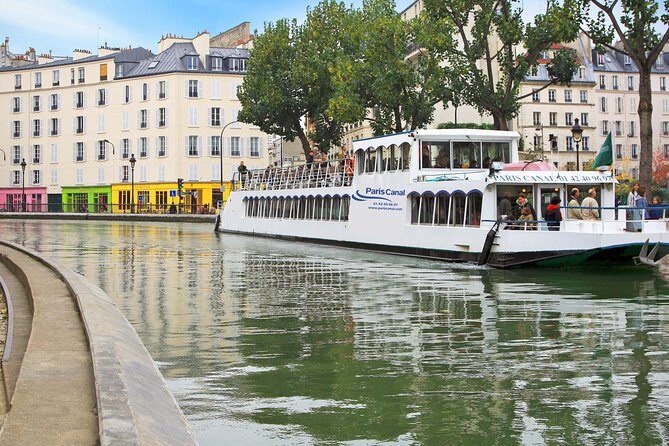 Seine River Cruise and Paris Canals Tour - Entering the Canal Saint-Martin: locks, footbridges, and the Bastille tunnel